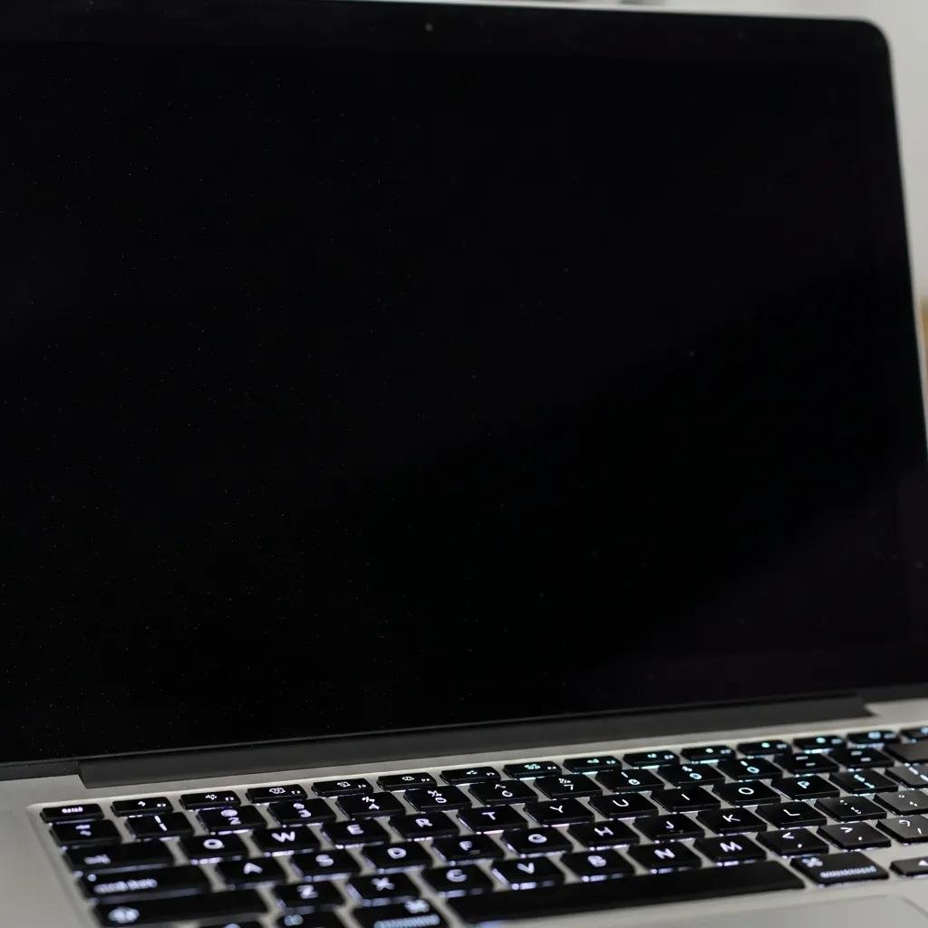 Close-up of a MacBook screen showing a black screen, highlighting boot issues and troubleshooting steps